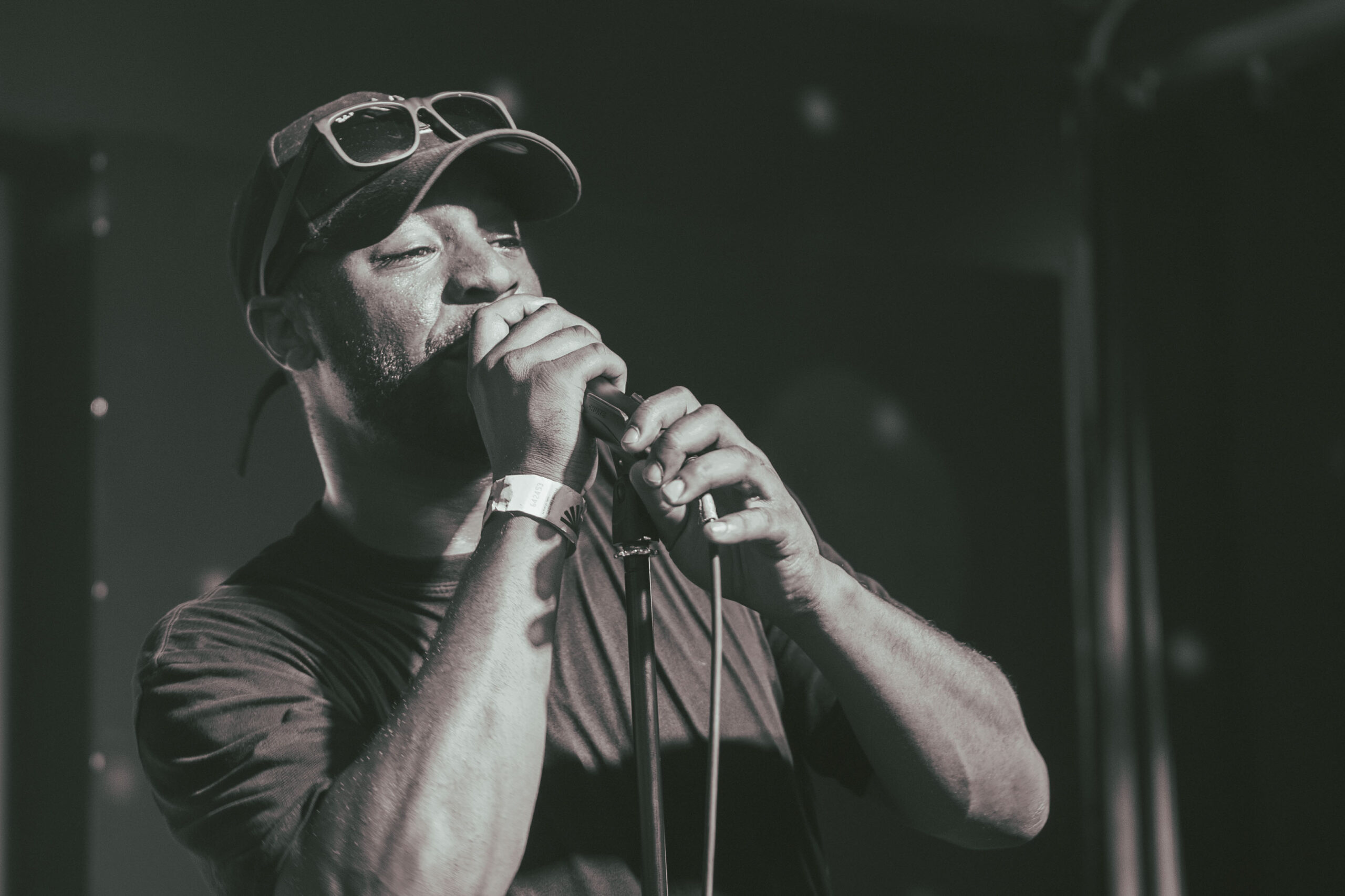 A performer at the microphone at The Bread & Roses