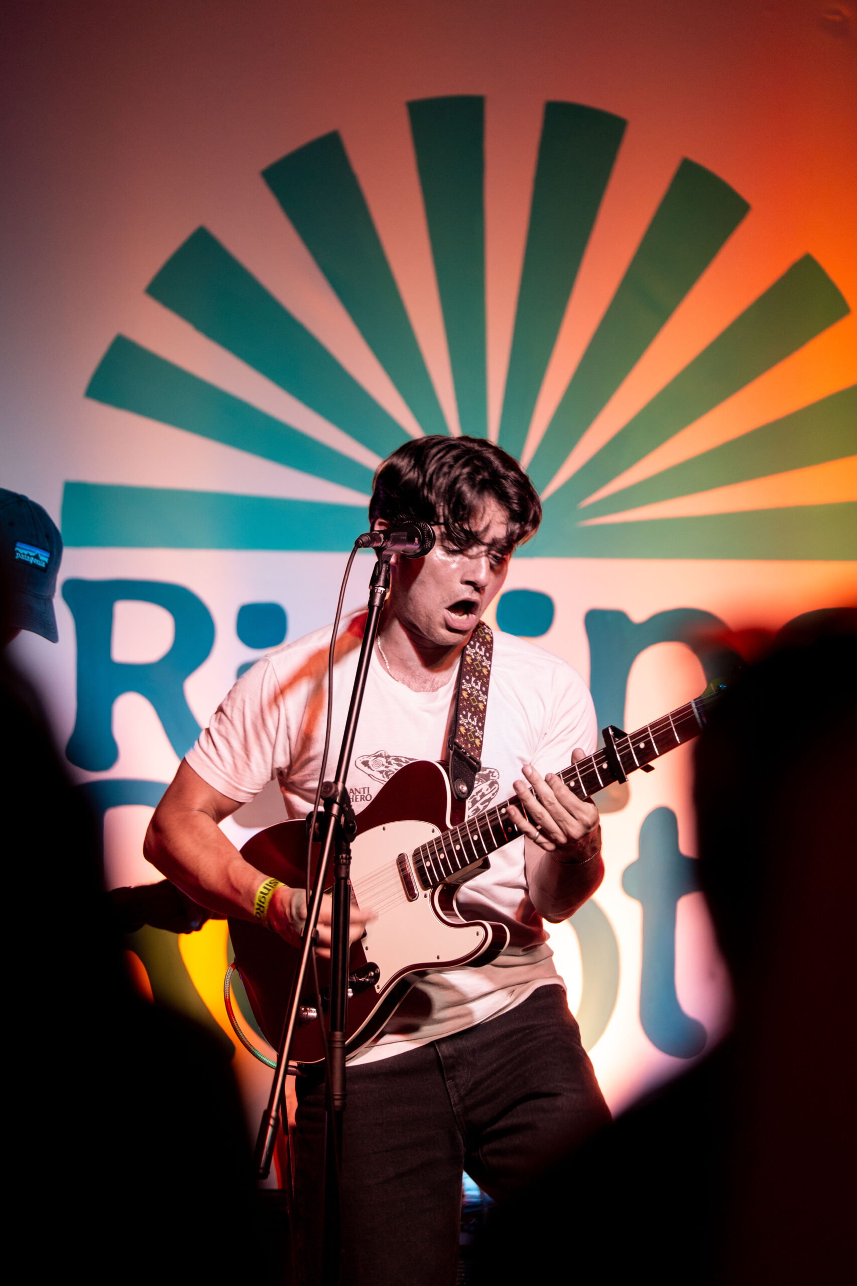 A guitarist singing on stage at The Bread & Roses